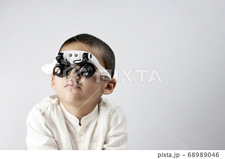 Handsome kid in magnifying headset glasses 68989046