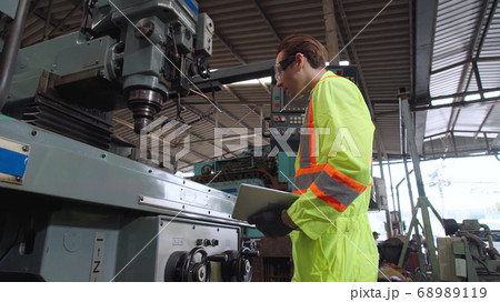 Smart factory worker using machine in factory workshop 68989119