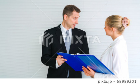 Two business people talk project strategy at office 68989201