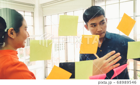 Business people work on project planning board 68989546