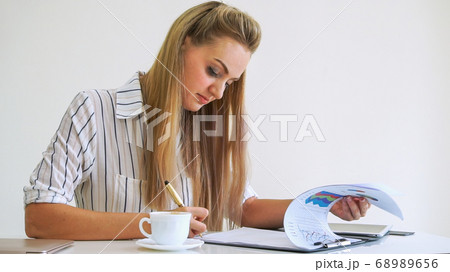 Blonde business woman working at modern office. 68989656