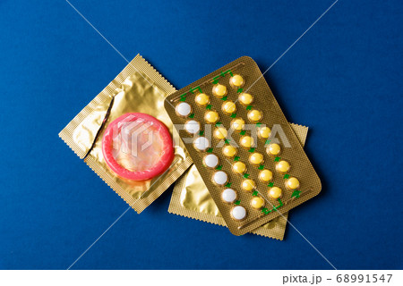 condom on wrapper pack and contraceptive pills 68991547