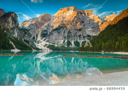 Fantastic wooden boats on the alpine lake, Dolomites, Italy 68994459