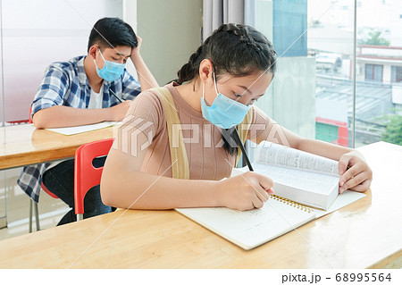 School children writing in copybooks School children writing in copybooks 68995564