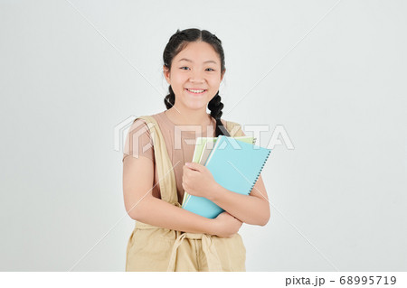 Schoolgirl with copybooks 68995719