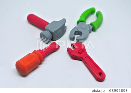 Toy carpentry tools are made of colorful soft rubber isolated on white background. Toy carpentry tools are made of colorful soft rubber isolated on white background. 68995893