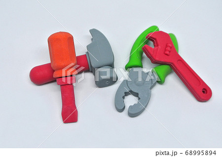 Toy carpentry tools are made of colorful soft rubber isolated on white background. Toy carpentry tools are made of colorful soft rubber isolated on white background. 68995894