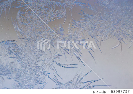 Snow patterns on glass as an abstract background Snow patterns on glass as an abstract background 68997737