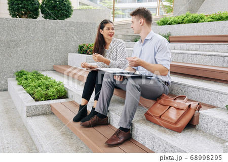 Business people discussing documents Business people discussing documents 68998295