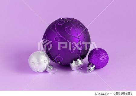 Purple and silver Christmas baubles on a lavender Purple and silver Christmas baubles on a lavender 68999885