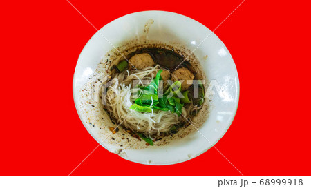 Thai style noodle soup in bowl red background 68999918
