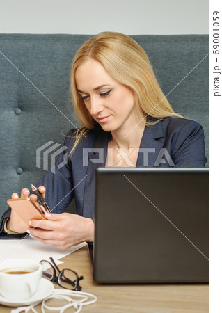 Woman is reading message on her cellphone. 69001059
