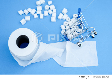 Toilet paper and shopping cart isolated on a blue background Toilet paper and shopping cart isolated on a blue background 69003628