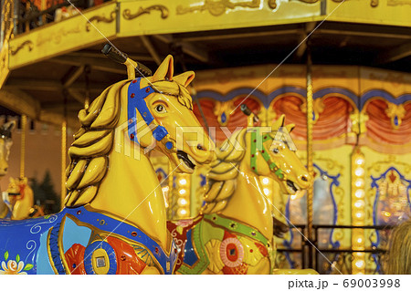 Colourful fairground carousel with bright colorful Colourful fairground carousel with bright colorful 69003998