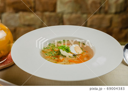 Fresh soup with vegetables, meat and eggs in a 69004383