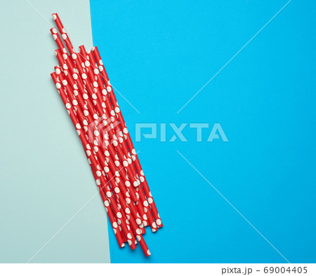 paper red cocktail tubes on a blue background paper red cocktail tubes on a blue background 69004405