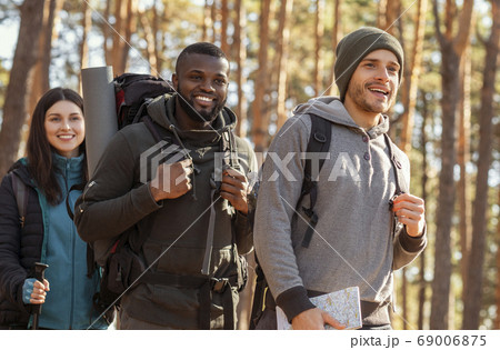International group of backpackers going by forest 69006875