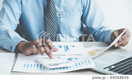Businessman analysis the chart with laptop at the office for setting challenging business goals Businessman analysis the chart with laptop at the office for setting challenging business goals 69008649