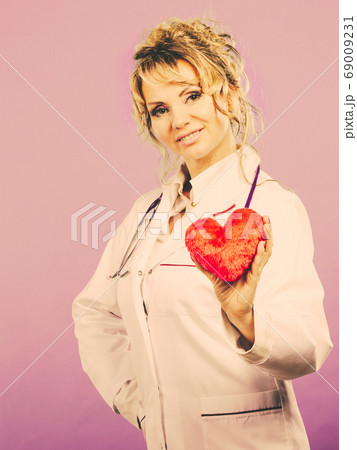 Middle aged blonde doctor enjoy her work. Middle aged blonde doctor enjoy her work. 69009231