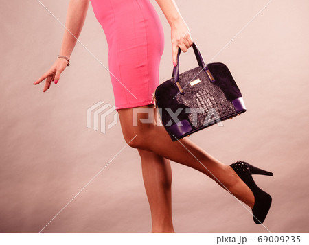 Mature fashion woman holds handbag Mature fashion woman holds handbag 69009235