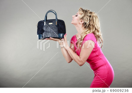 Elegant woman buyer with dep blue bag. Elegant woman buyer with dep blue bag. 69009236