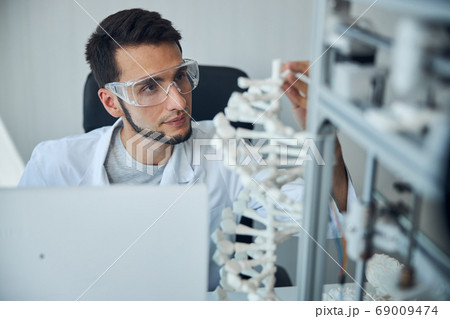Medical student examining the 3D printed DNA model 69009474