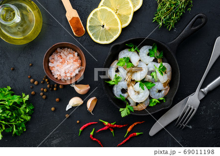 Top view of pan with raw prawn with spice and 69011198