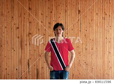 Man wearing Trinidad and Tobago flag color shirt and standing with two hands in pant pockets Man wearing Trinidad and Tobago flag color shirt and standing with two hands in pant pockets 69011596