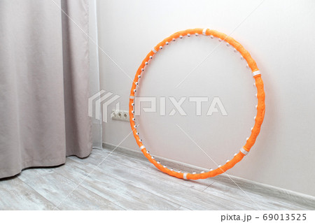 Hula hoop for gymnastics at home. weight loss concept. Sport equipment Hula hoop for gymnastics at home. weight loss concept. Sport equipment 69013525
