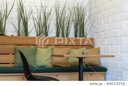 table and a wooden bench with pillows. interior of a room for eating. 69014358