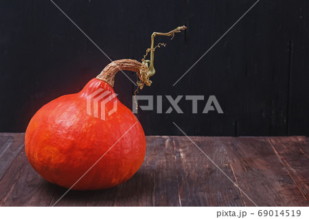 Hokkaido Pumpkin on the wooden table with black background. Hokkaido Pumpkin on the wooden table with black background. 69014519
