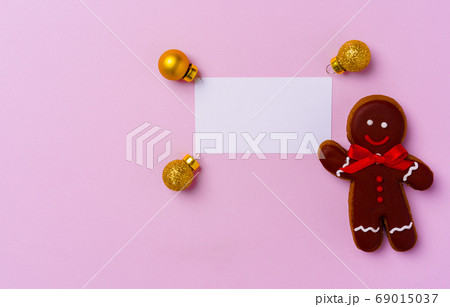 Mock up of holiday greeting card with gingerbread cookies on pink background 69015037