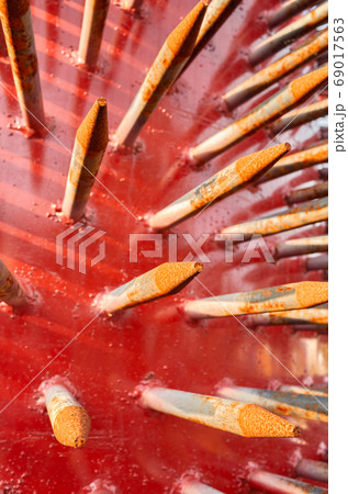 Close up picture of rusty spikes of an old spiked aerator roller Close up picture of rusty spikes of an old spiked aerator roller 69017563