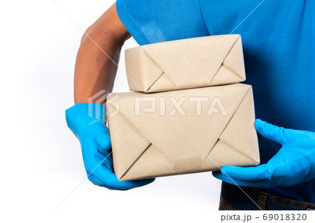 Delivery man holding and carrying a card box 69018320