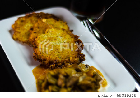 potato pancakes with spicy stew, delicious 69019359