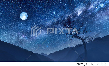 Night sky with moon and milky way over mountains 69020823