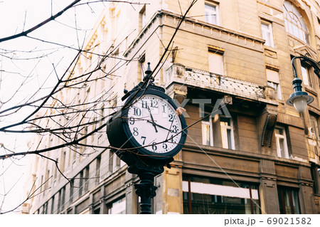 An old street post with a clock, on the streets of Budapest. An old street post with a clock, on the streets of Budapest. 69021582