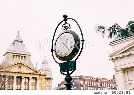 An old street post with a clock, on the streets of Budapest. An old street post with a clock, on the streets of Budapest. 69022291