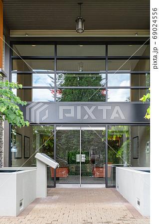 Entrance of new residential building with paved area in front 69024556