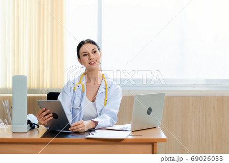 Doctor women working and checking disease examination results on laptop Doctor women working and checking disease examination results on laptop 69026033