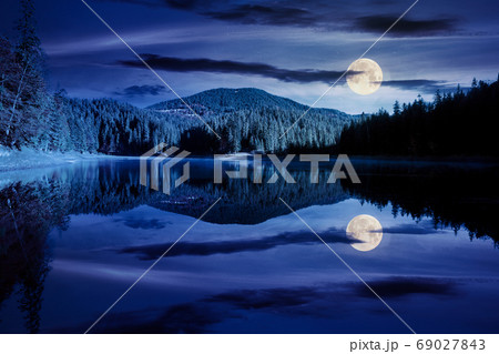 mountain lake among the forest at night. trees in colorful folia 69027843