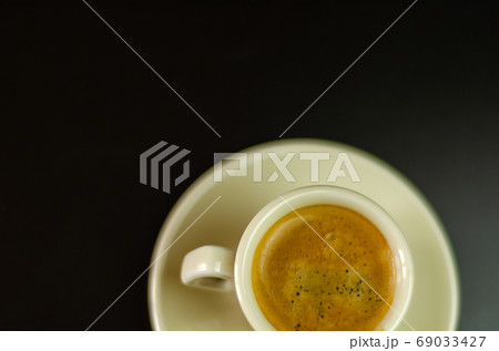 black coffee in a ceramic cup on the bar, energy 69033427