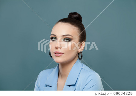 Cute woman brunette on blue background 69034829