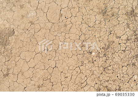 Dry ground rough cracks in the land with sand in desert. serious Dry ground rough cracks in the land with sand in desert. serious 69035330
