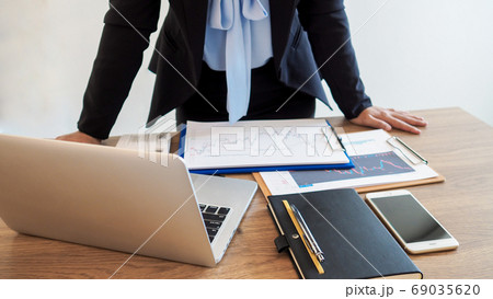 Business trader woman analyze stock graph and report set targets for online trading Business trader woman analyze stock graph and report set targets for online trading 69035620