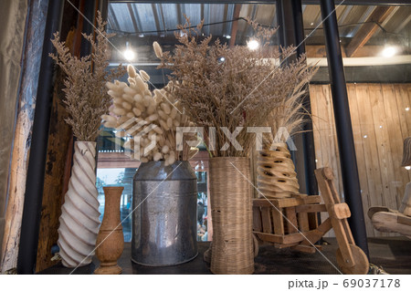 Brown dried flowers in various shape vases Brown dried flowers in various shape vases 69037178