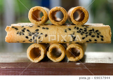 Big pile of fresh Wafer rolls with sesame Big pile of fresh Wafer rolls with sesame 69037944