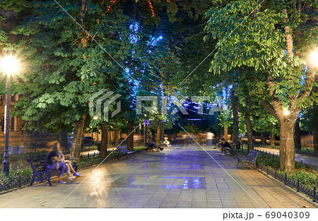 night view of Primorsky boulevard in Odessa city, Ukraine. Beautiful city Park and street illumination, walking people night view of Primorsky boulevard in Odessa city, Ukraine. Beautiful city Park and street illumination, walking people 69040309