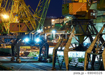 view of the industrial port at night - ships waiting for loading and unloading, cargo transportation by sea 69040326