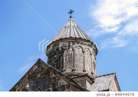 Stone umbrella dome with iron cross at the Church of Blessed Holy Mother,in the monastery of Haghartsin near Dilijan 69044076